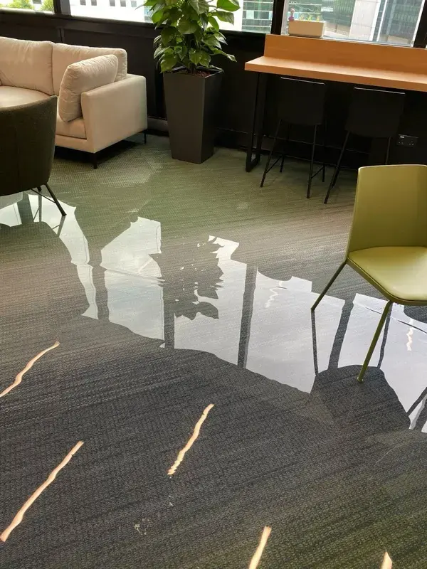 Standing water across an office lounge floor in an El Monte commercial building